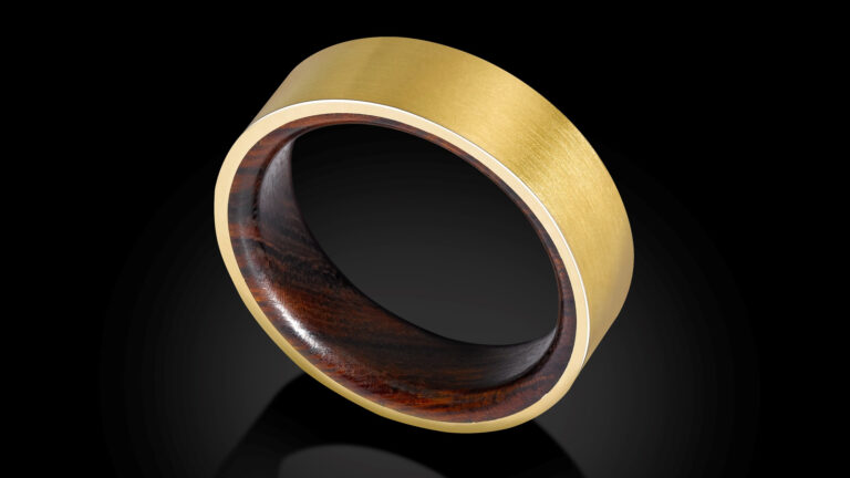 Bespoke 18ct yellow gold wedding ring with a smooth matte finish and an inner inlay of richly grained ironwood.