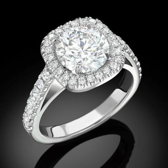 Platinum halo diamond engagement ring featuring a round brilliant-cut centre stone surrounded by micro pavé-set diamonds by Icecool diamonds.