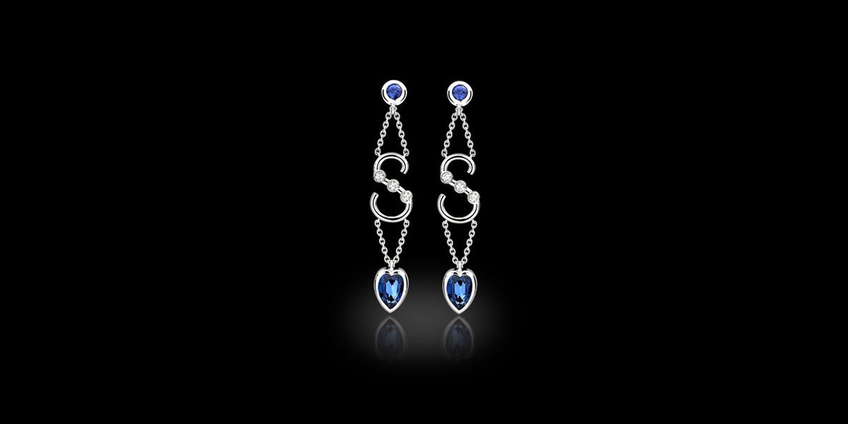 Bespoke sapphire and diamond drop earrings featuring an S initial and heart-shaped sapphires, handcrafted by Icecool Diamonds in Hatton Garden.